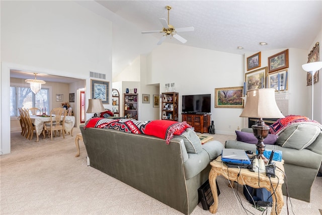 carpeted living room with high vaulted ceiling and ceiling fan