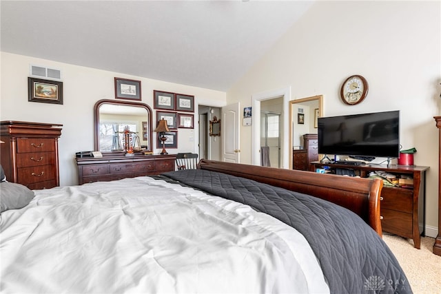 carpeted bedroom with lofted ceiling