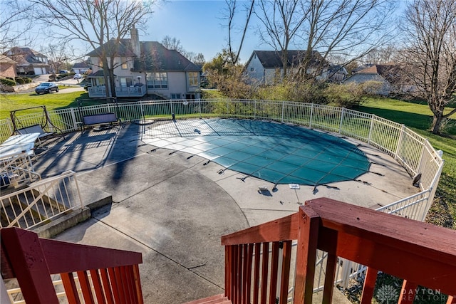 view of pool featuring a yard and a patio