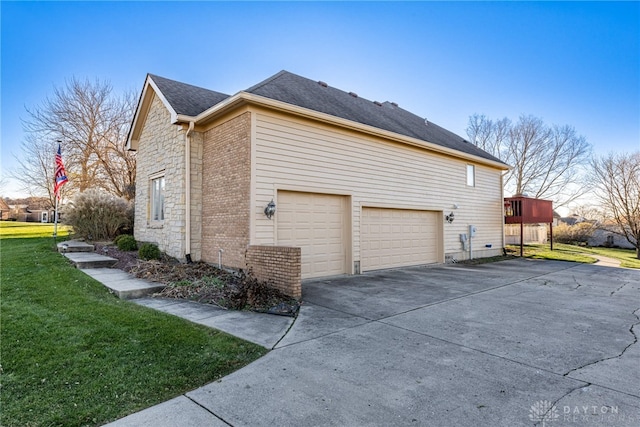 view of home's exterior featuring a yard, a garage, and a wooden deck