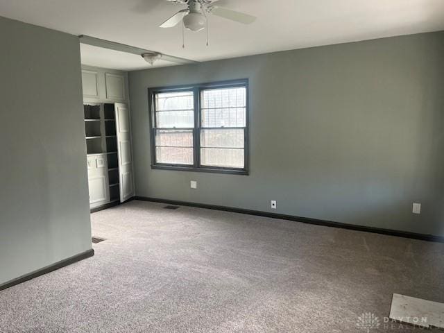 unfurnished room with ceiling fan and light colored carpet