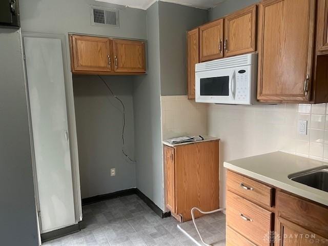 kitchen with decorative backsplash and sink