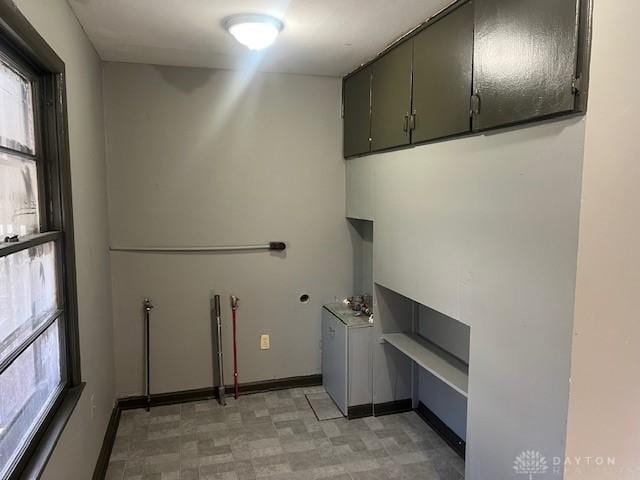 laundry area featuring cabinets