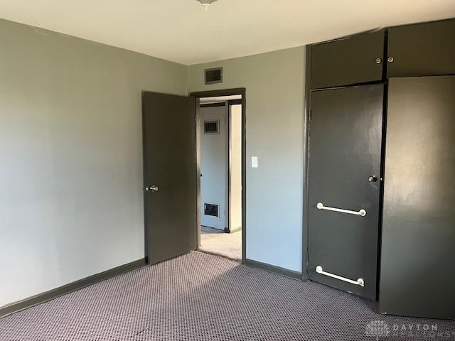 unfurnished bedroom with carpet and a closet