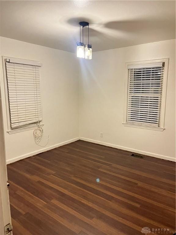 unfurnished room with dark hardwood / wood-style floors