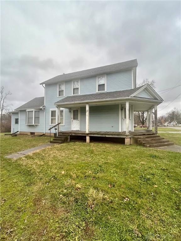 view of front facade with covered porch and a front yard