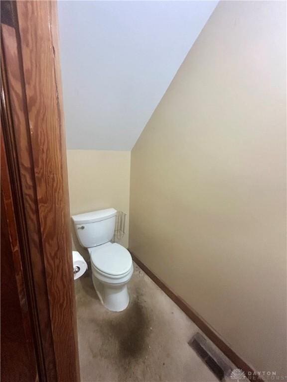 bathroom featuring toilet and vaulted ceiling