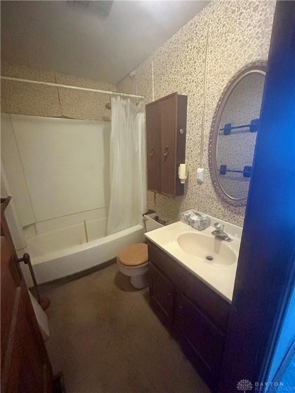 full bathroom with vanity, shower / bath combo, and toilet