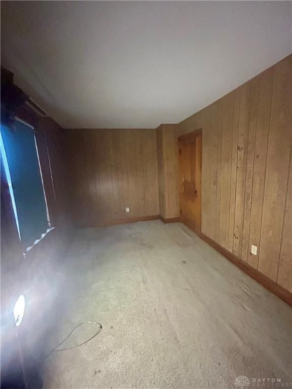 empty room featuring wood walls