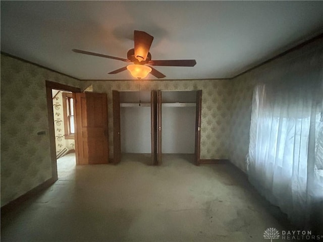 unfurnished bedroom with ceiling fan and multiple windows