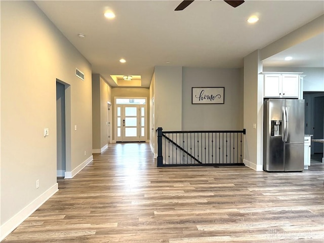 interior space with light hardwood / wood-style flooring and ceiling fan