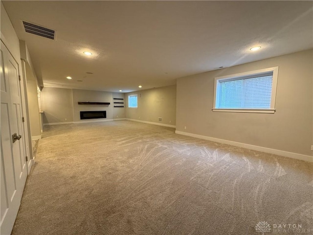 unfurnished living room with light colored carpet