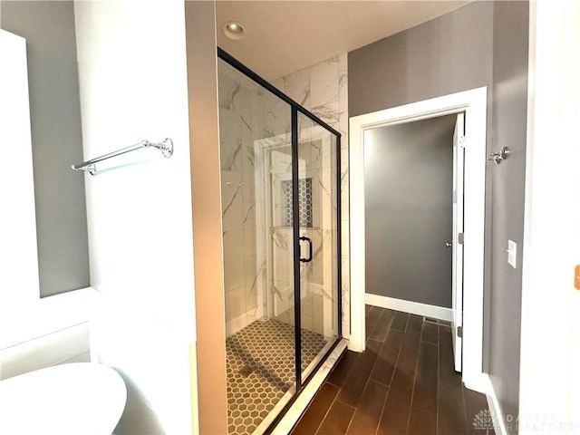 bathroom featuring an enclosed shower and hardwood / wood-style flooring