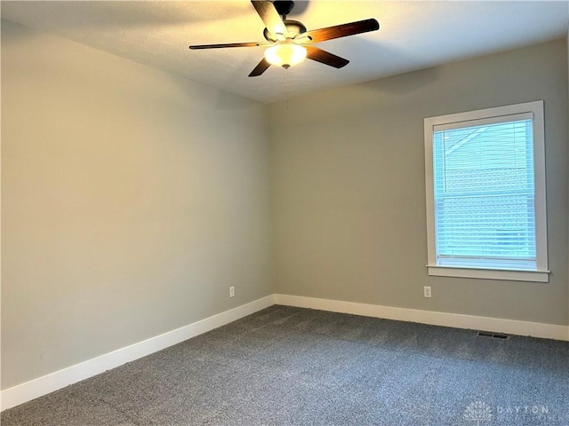 carpeted empty room featuring ceiling fan