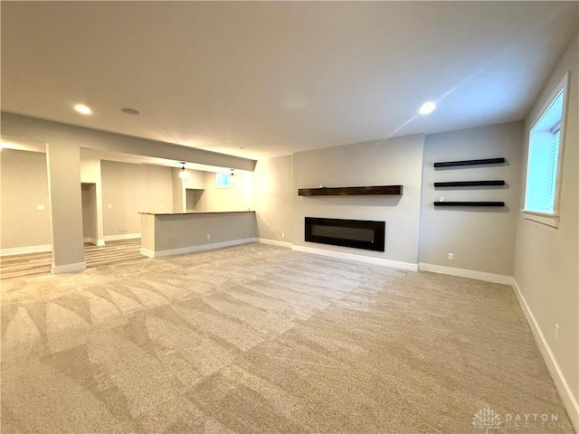 unfurnished living room featuring light colored carpet