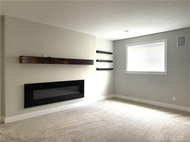 unfurnished living room with light colored carpet