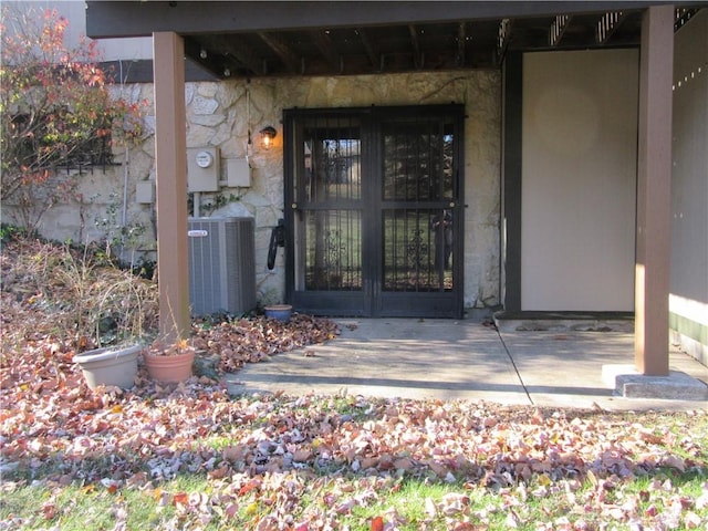 property entrance with central air condition unit and french doors