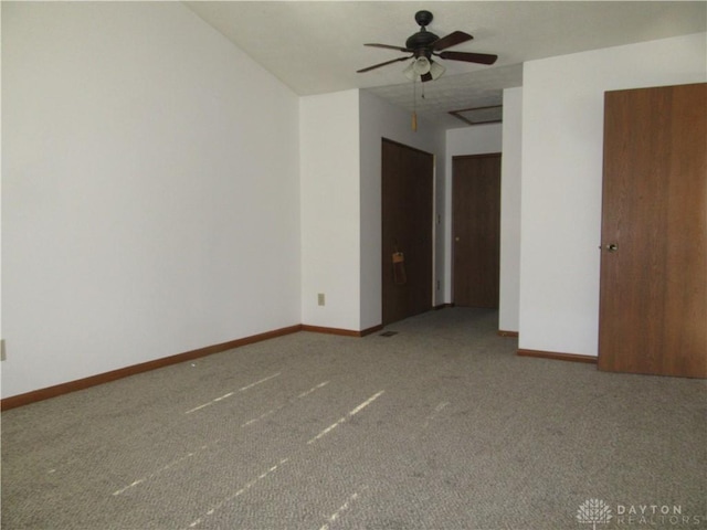 empty room featuring ceiling fan and carpet floors