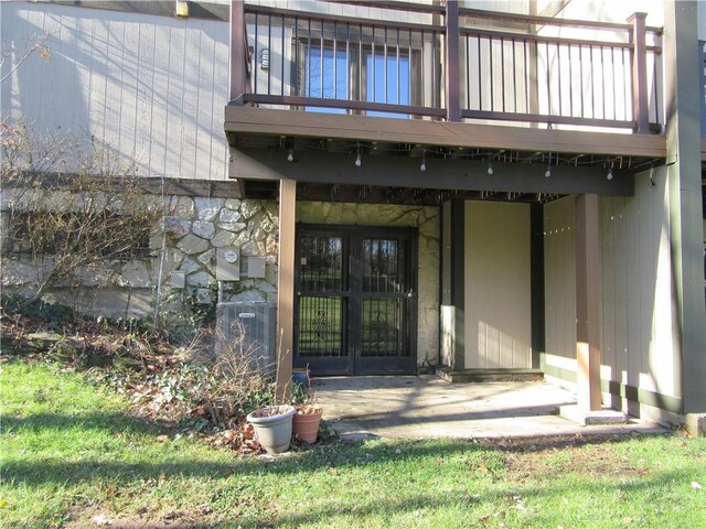 entrance to property with french doors, central AC, and a wooden deck