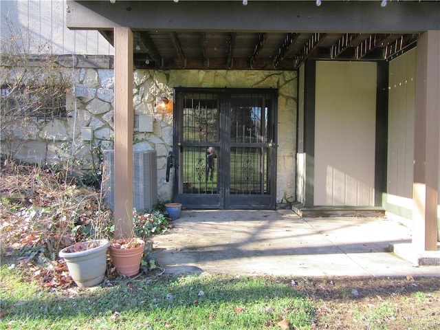 view of exterior entry with french doors and central air condition unit