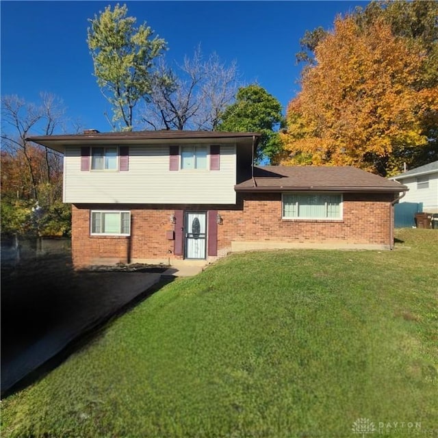 rear view of property featuring a lawn