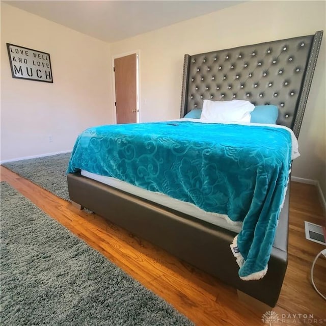 bedroom with hardwood / wood-style floors