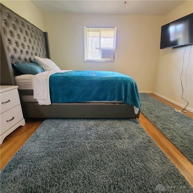 bedroom with hardwood / wood-style floors