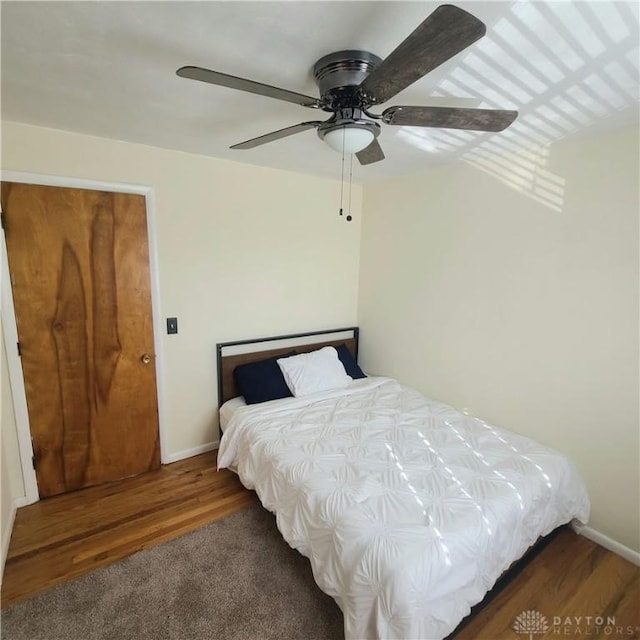 bedroom featuring ceiling fan and dark hardwood / wood-style flooring