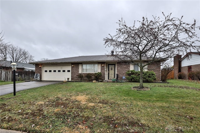 ranch-style home with a garage and a front lawn