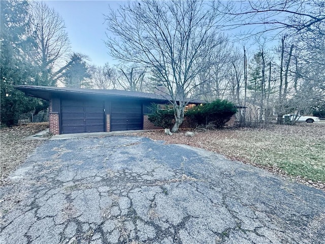 view of front of property featuring a garage and brick siding