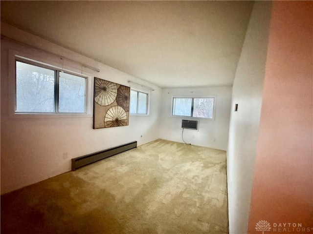 empty room with baseboard heating, a wall unit AC, and carpet flooring