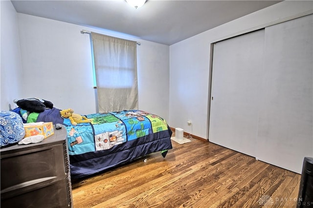 bedroom featuring hardwood / wood-style floors and a closet