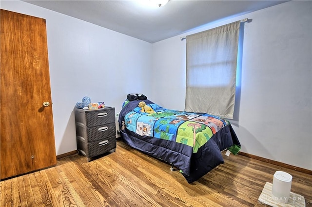 bedroom with hardwood / wood-style floors