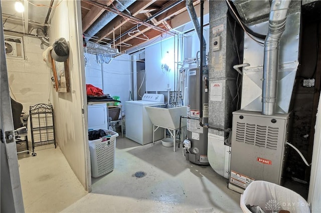 basement with washer and clothes dryer, sink, and water heater