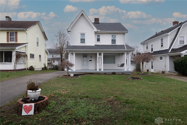 front of property with a front lawn and covered porch