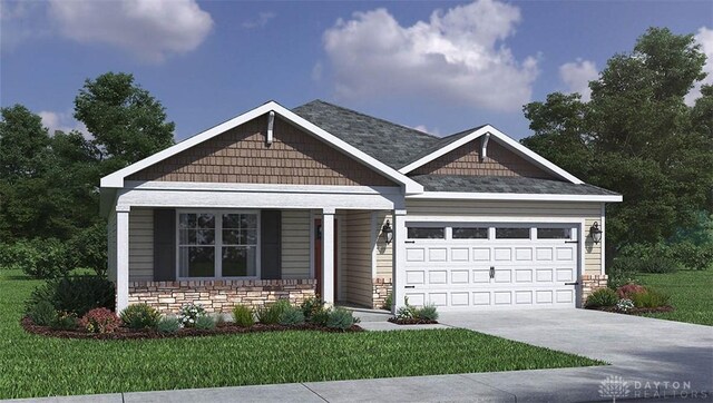 craftsman inspired home featuring a garage and a front yard