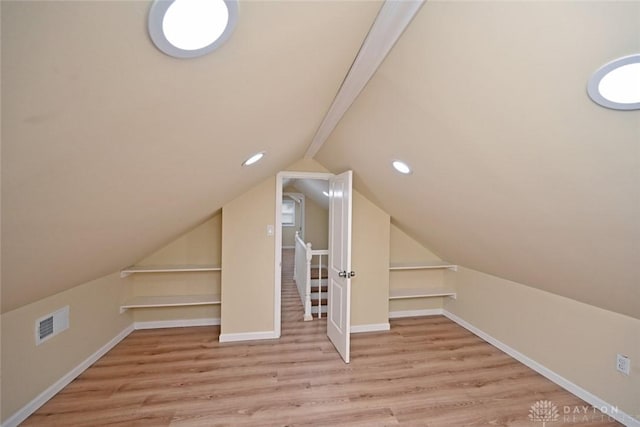 bonus room featuring light hardwood / wood-style flooring and vaulted ceiling