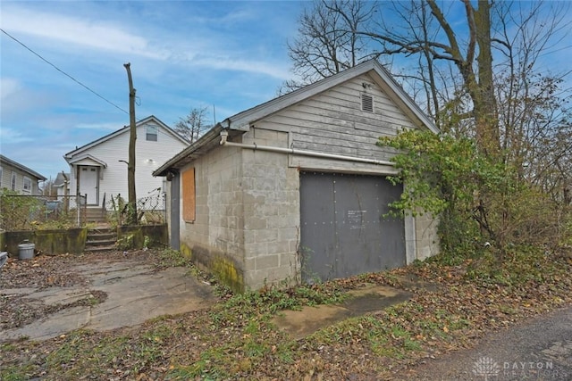 view of side of property with a garage and an outdoor structure