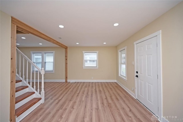 foyer entrance featuring plenty of natural light and light hardwood / wood-style flooring