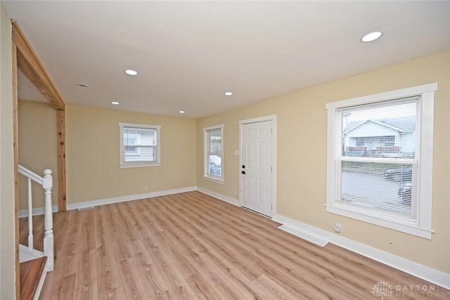 foyer featuring light wood-type flooring and a healthy amount of sunlight