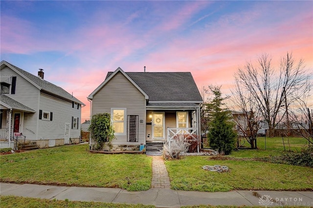 bungalow with a lawn and covered porch