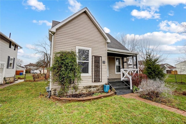 view of front of house with a front yard and a porch