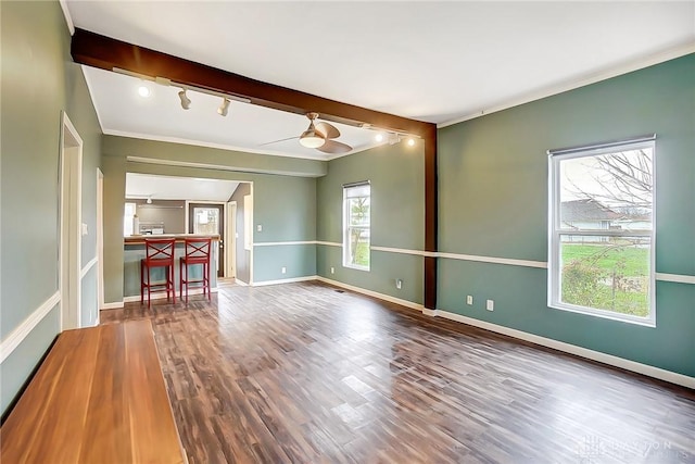 unfurnished room with crown molding, beamed ceiling, and wood-type flooring