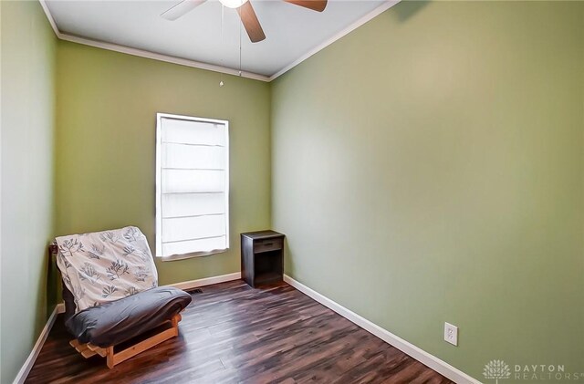 sitting room featuring ceiling fan, dark hardwood / wood-style flooring, and crown molding