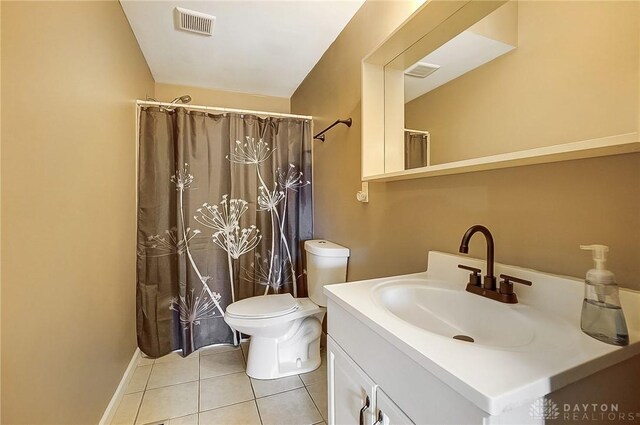 bathroom featuring tile patterned floors, curtained shower, vanity, and toilet