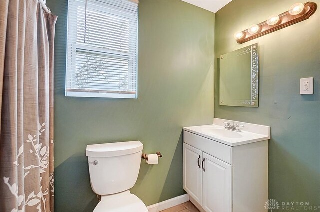 bathroom featuring tile patterned flooring, vanity, and toilet