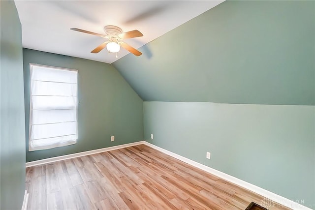 additional living space featuring vaulted ceiling, light hardwood / wood-style floors, and ceiling fan