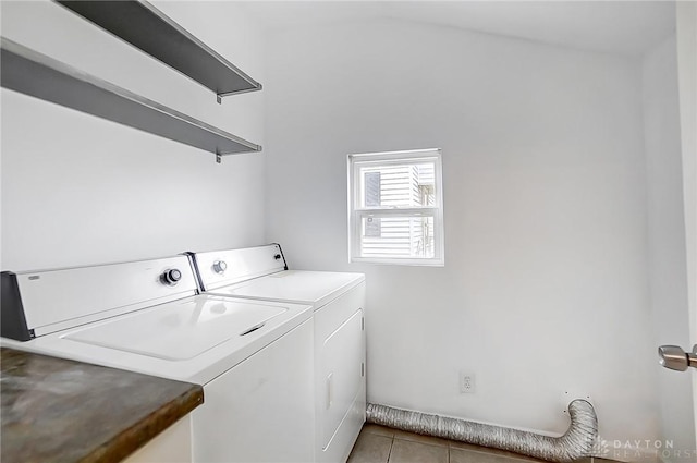 laundry area with light tile patterned floors and washing machine and dryer