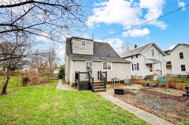 back of property with a yard, a patio, and central air condition unit