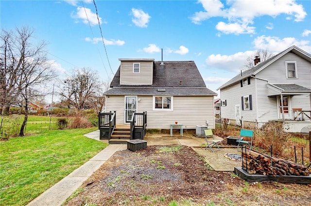 back of property with a lawn, a patio, and central AC unit